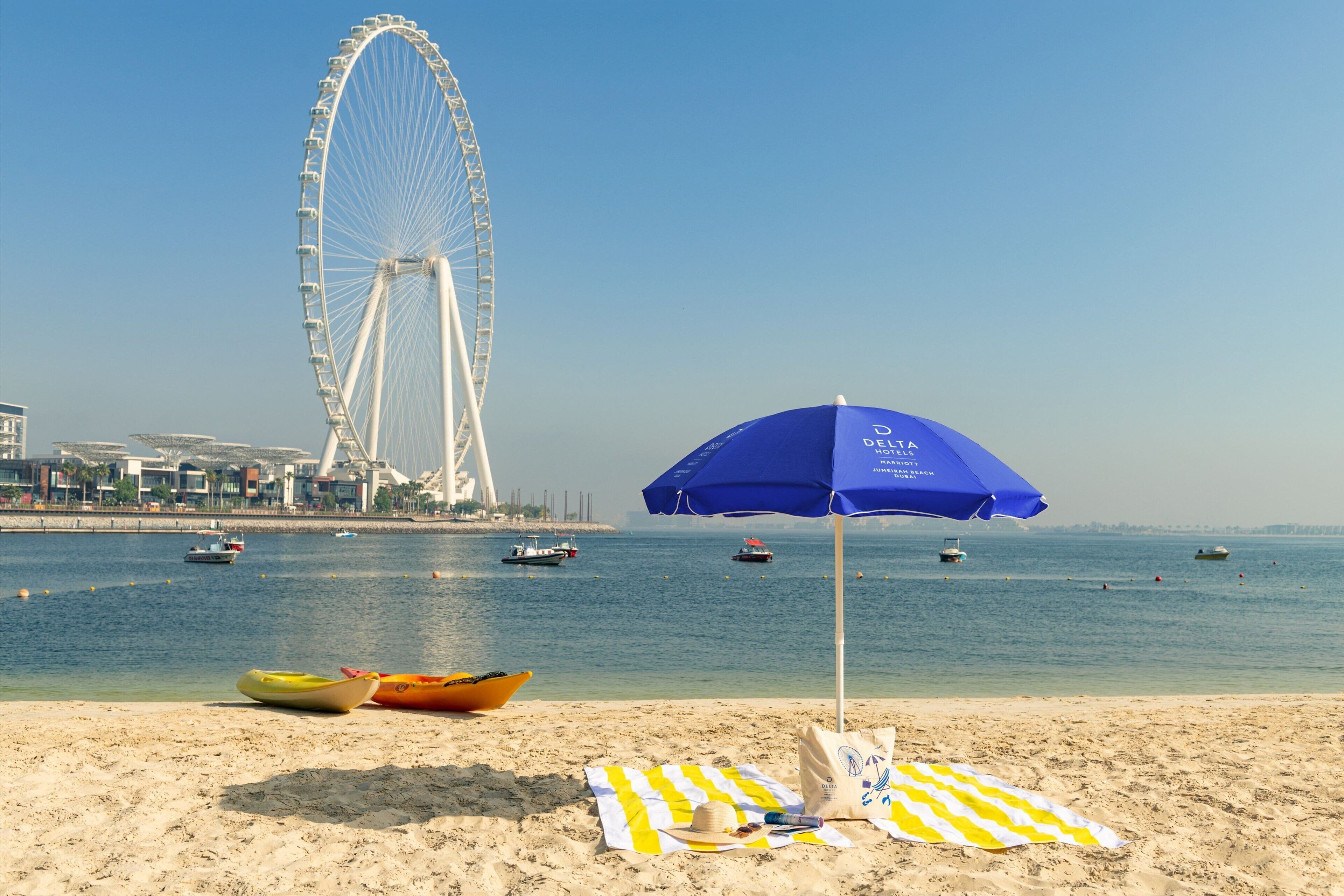 beach nearby, white sand, beach umbrellas, beach towels
