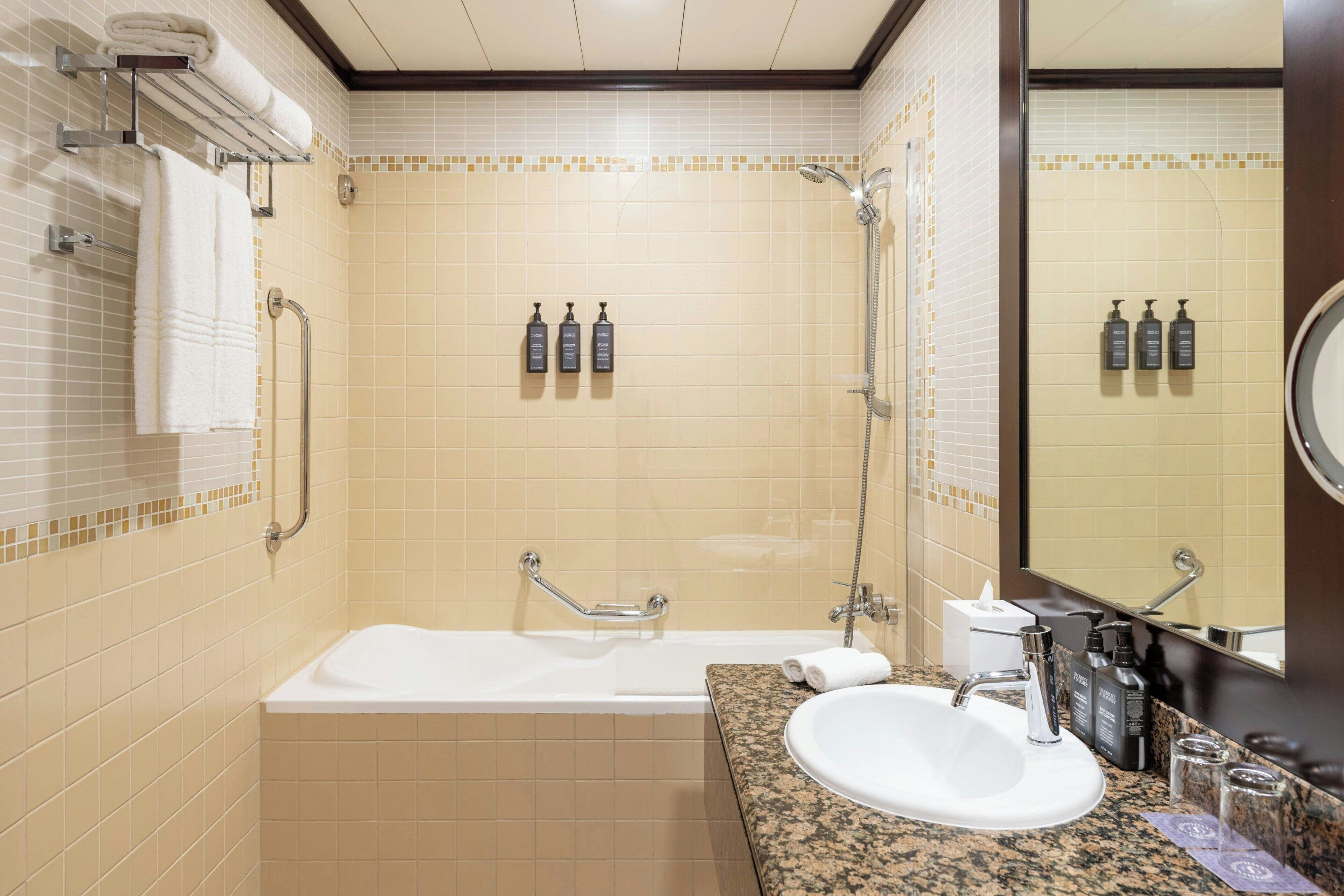 A modern bathroom with a bathtub, a sink, and a shower.