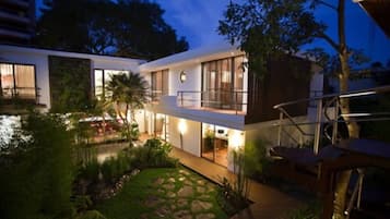 Enjoy a peaceful retreat in this two-story residence with a garden, outdoor seating area, and balcony.