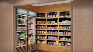 A snack and beverage kiosk with refrigerated drinks and a variety of snacks and packaged goods. - Fairfield Inn & Suites Baltimore BWI Airport (Linthicum Heights)