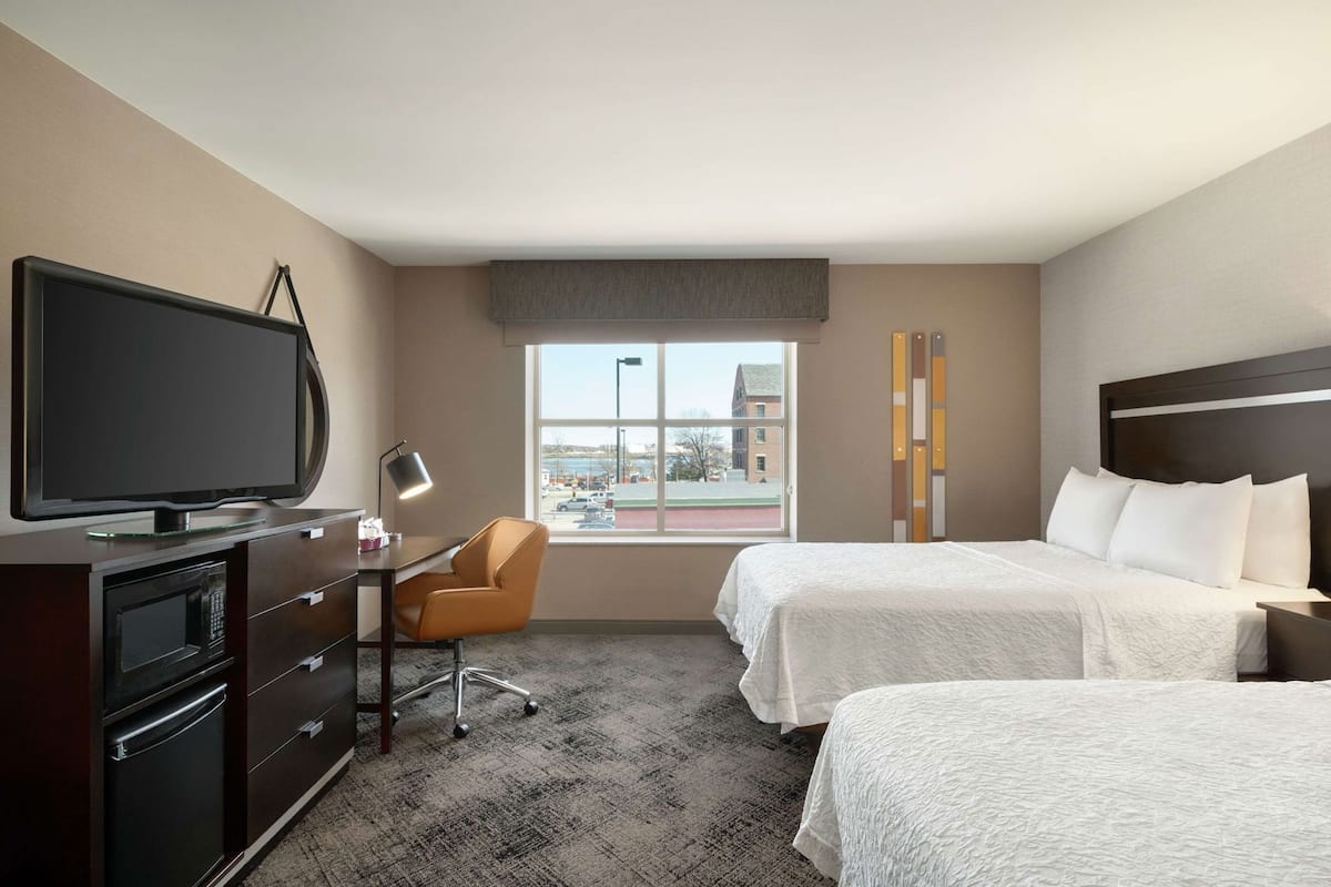 Hypo-allergenic bedding, desk, laptop workspace, blackout drapes