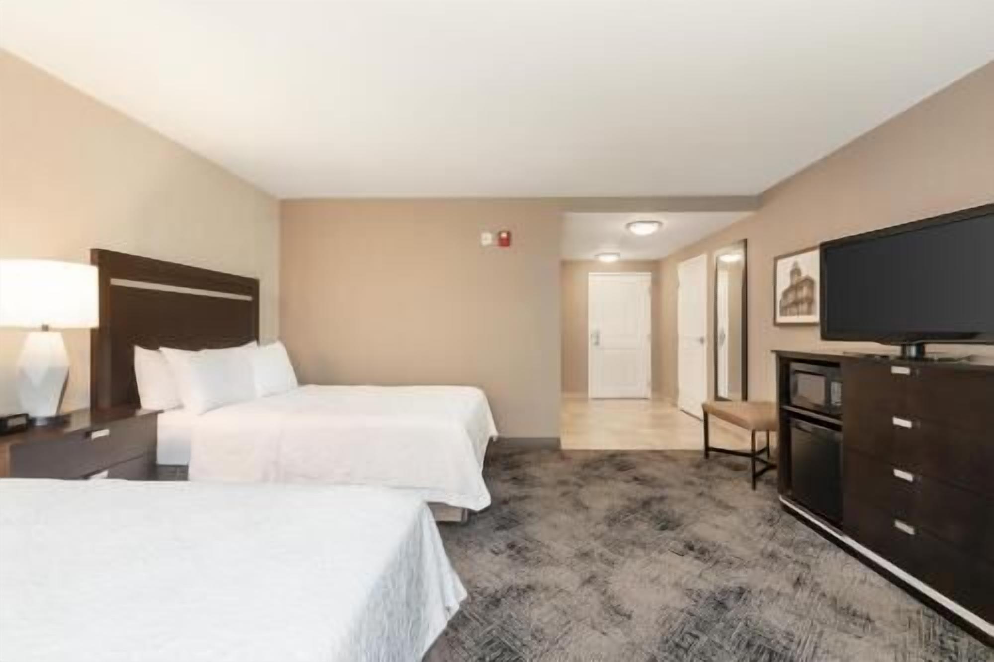 Hypo-allergenic bedding, desk, laptop workspace, blackout drapes