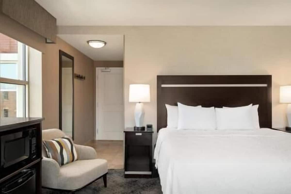 Hypo-allergenic bedding, desk, laptop workspace, blackout drapes