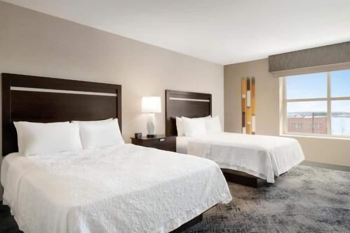 Hypo-allergenic bedding, desk, laptop workspace, blackout drapes