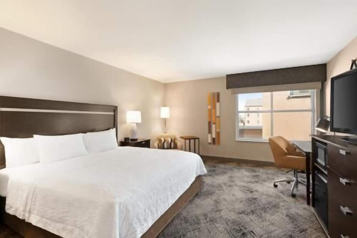 Hypo-allergenic bedding, desk, laptop workspace, blackout drapes