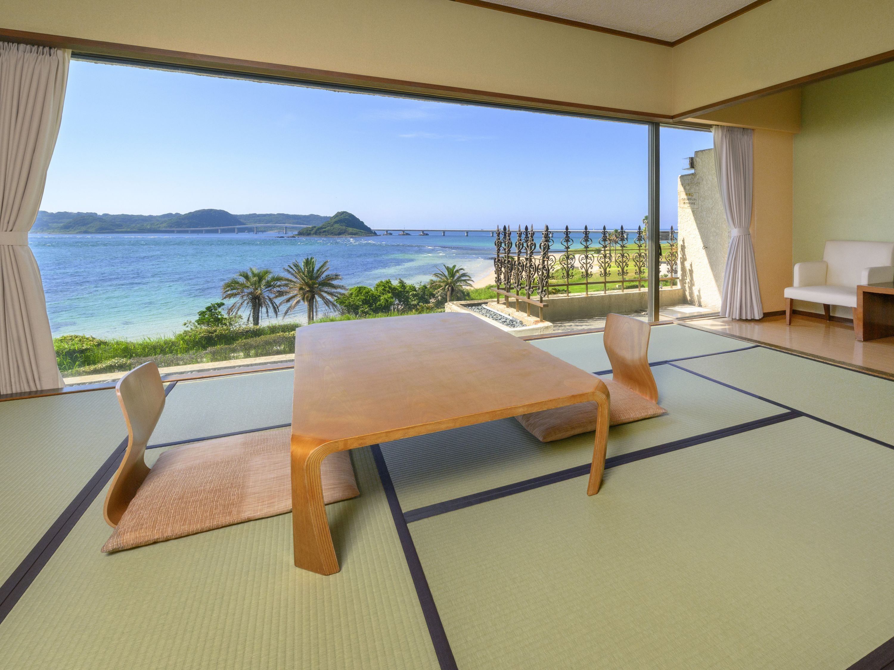 A tatami mat room with a view of the sea and mountains.
