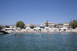 A waterfront hotel with multiple buildings, a pool area, and beachside amenities. - Sacallis Inn Beach Hotel (Kos)