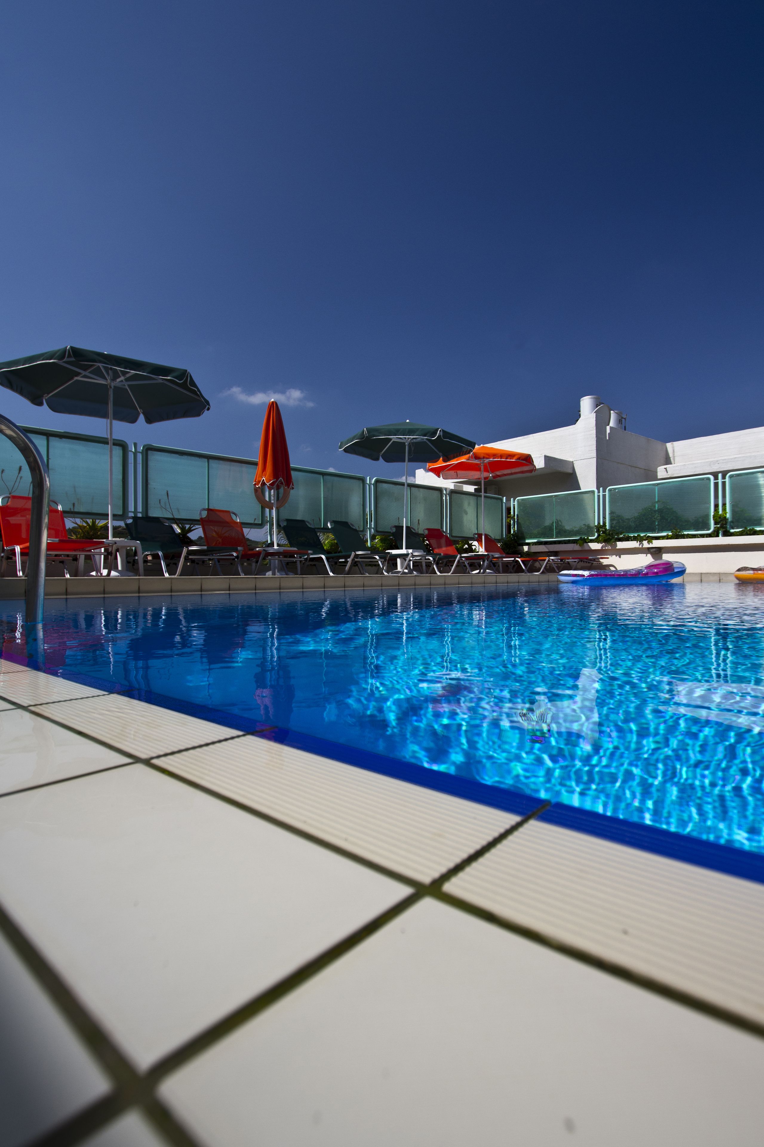 seasonal outdoor pool, open 9:00 am to 9:00 pm, pool umbrellas