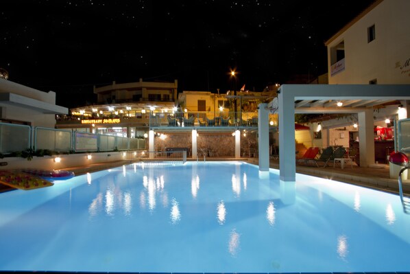 Seasonal outdoor pool, open 9:00 AM to 9:00 PM, pool umbrellas