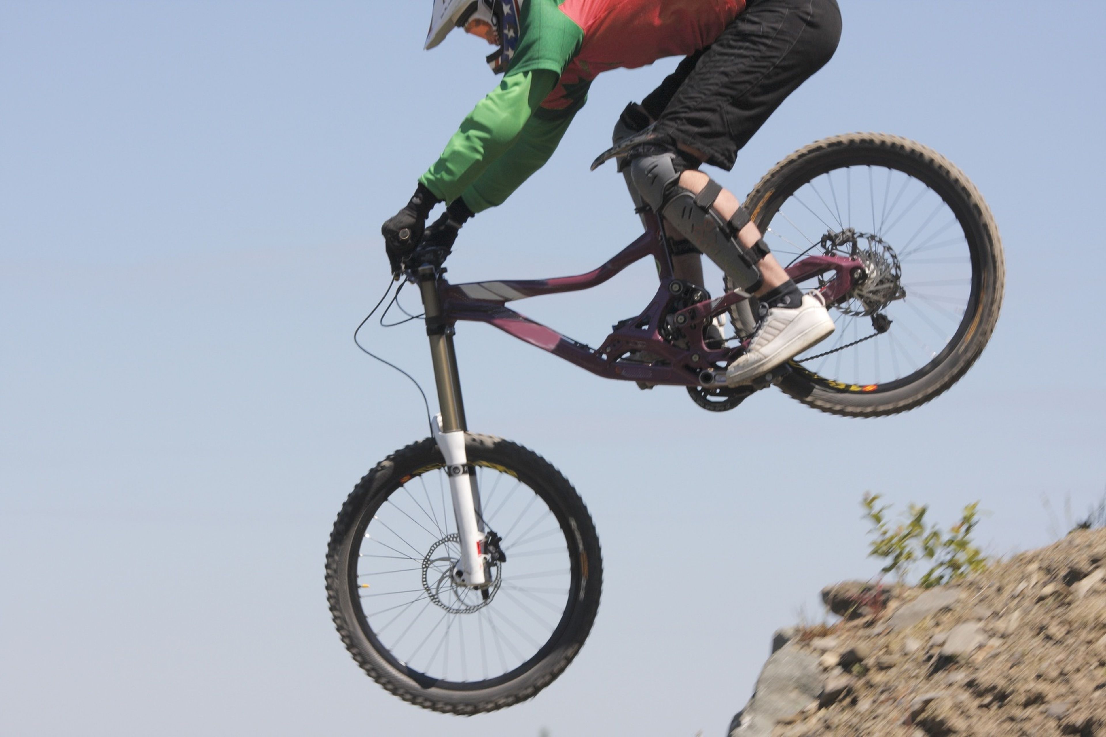 A mountain biker in mid-air performing a jump.