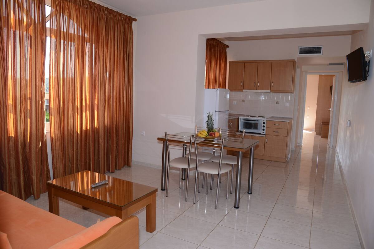A modern kitchen with wooden cabinets, a microwave, and a refrigerator.