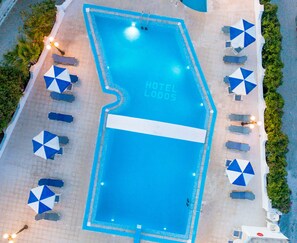 Seasonal outdoor pool, open 9:00 AM to 8:00 PM, pool umbrellas