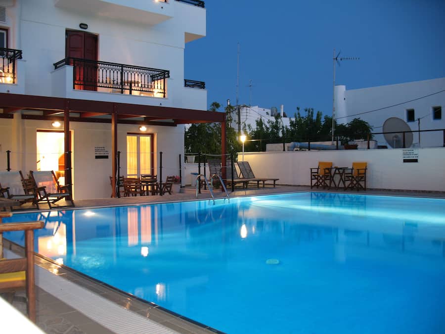 Una piscina al aire libre, sillones reclinables de piscina