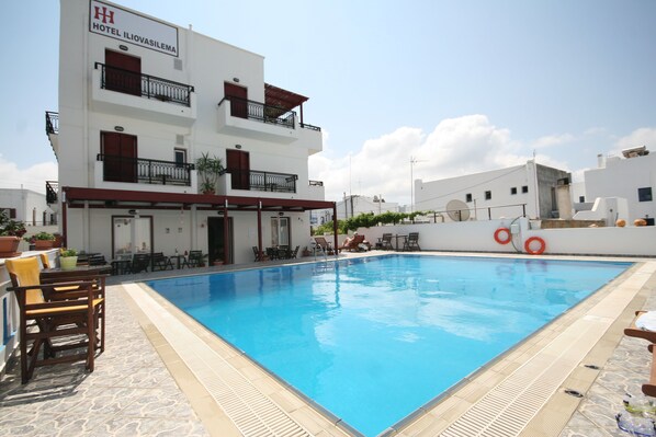 Una piscina al aire libre, tumbonas