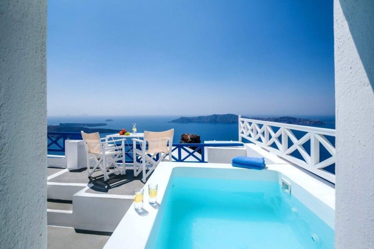 A rooftop pool with a clear view of the sea and distant islands.