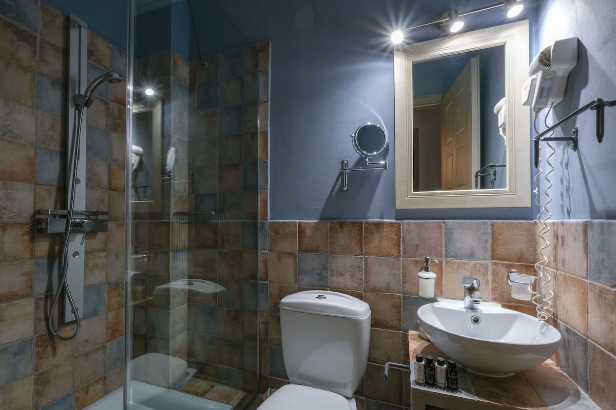 shower, hair dryer, slippers, towels