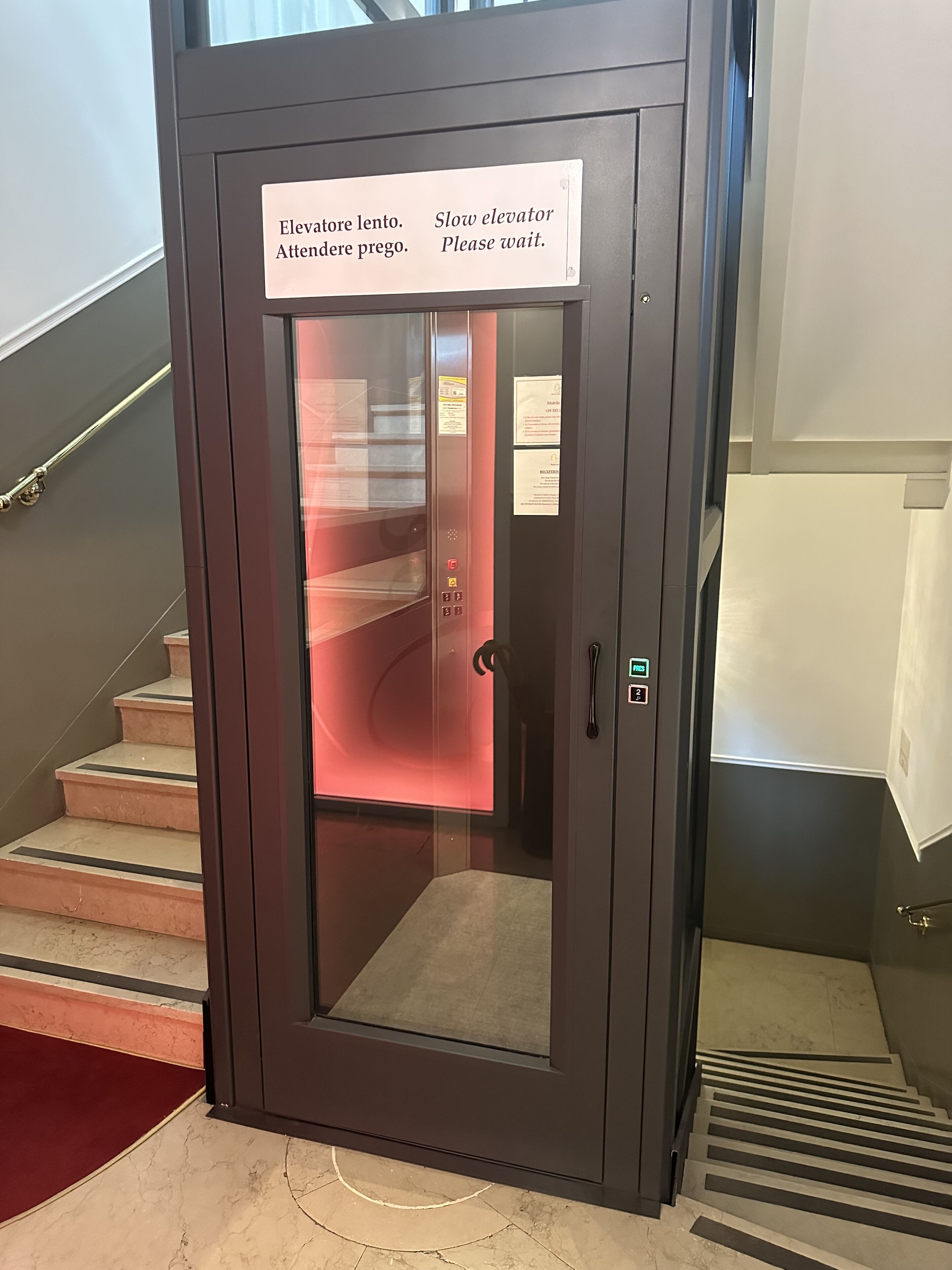 An elevator with a sign instructing to slow down and wait.
