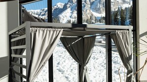 A modern outdoor seating area with a view of snow-capped mountains. - Ambiez Residence (Pinzolo)