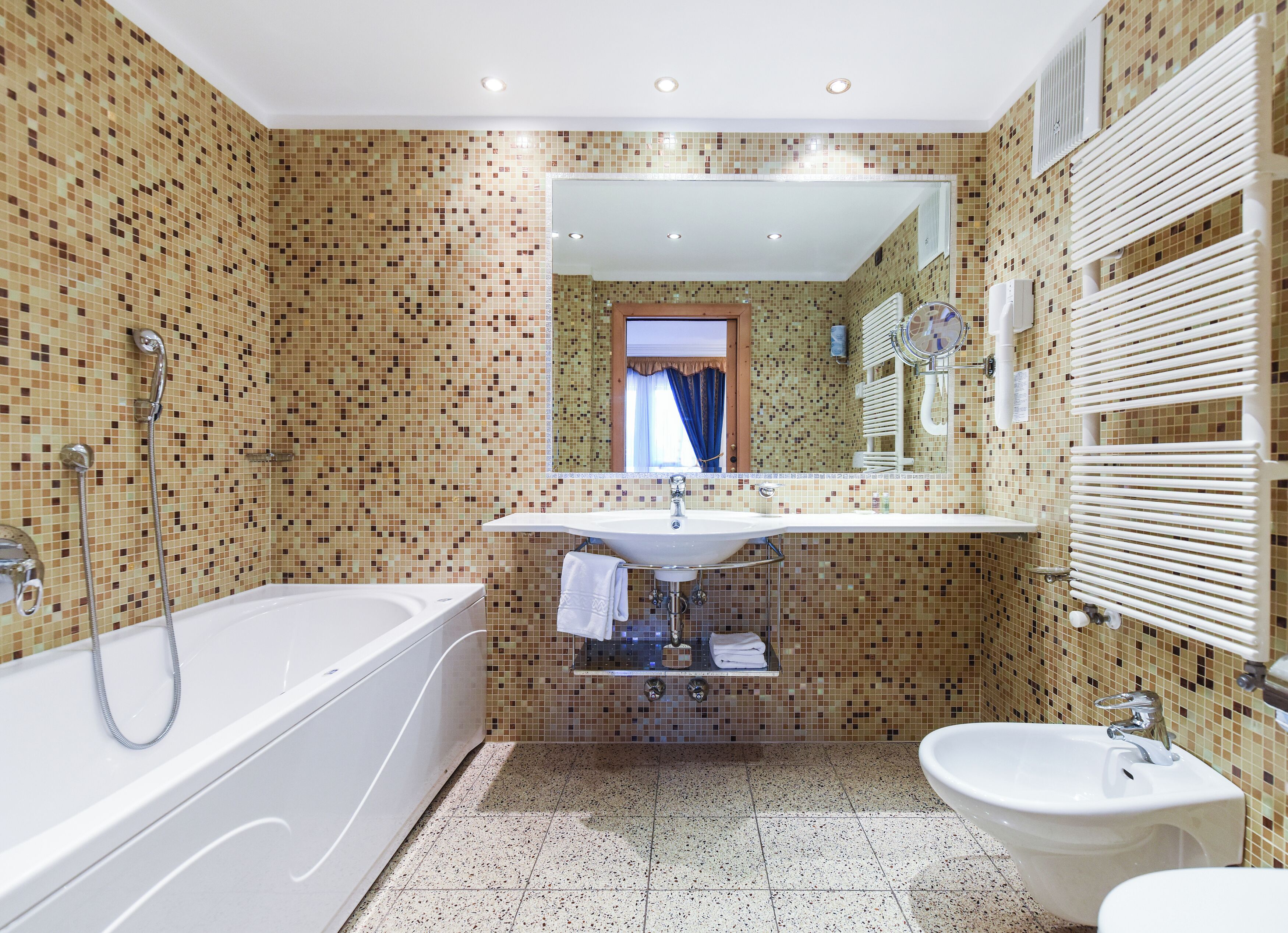 A bathroom with a bathtub, a sink, and a bidet.