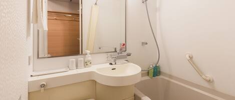 A bathroom with a sink, mirror, and shower.