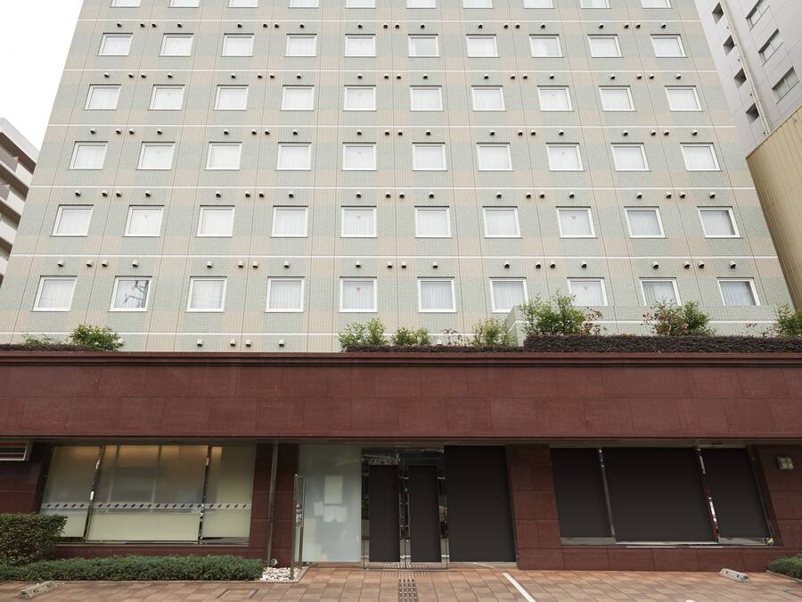 A multi-story building with a flat facade, numerous windows, and a ground-level entrance.