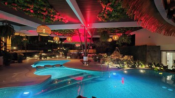 Una piscina techada, sillones reclinables de piscina