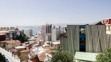A cityscape with a variety of buildings, including a prominent modern structure with a unique facade.