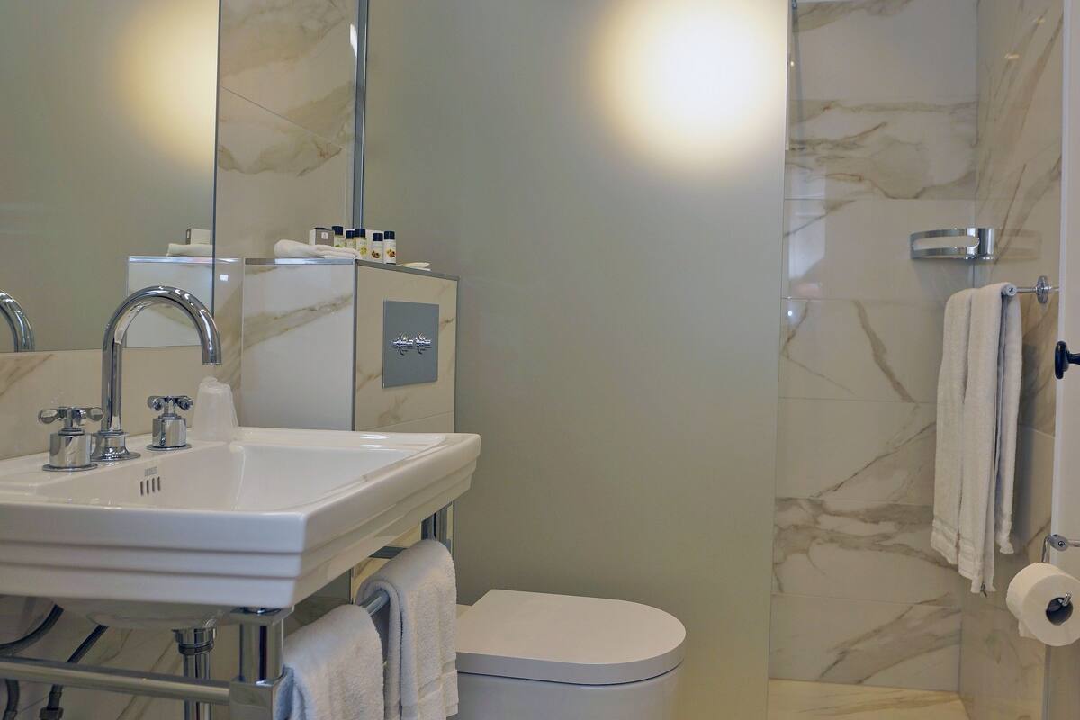 rainfall showerhead, designer toiletries, hair dryer, bathrobes