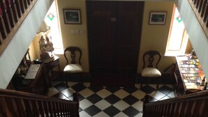 A staircase with red carpeted steps leading up to a door. - Deerpark Manor Bed & Breakfast (Swinford)