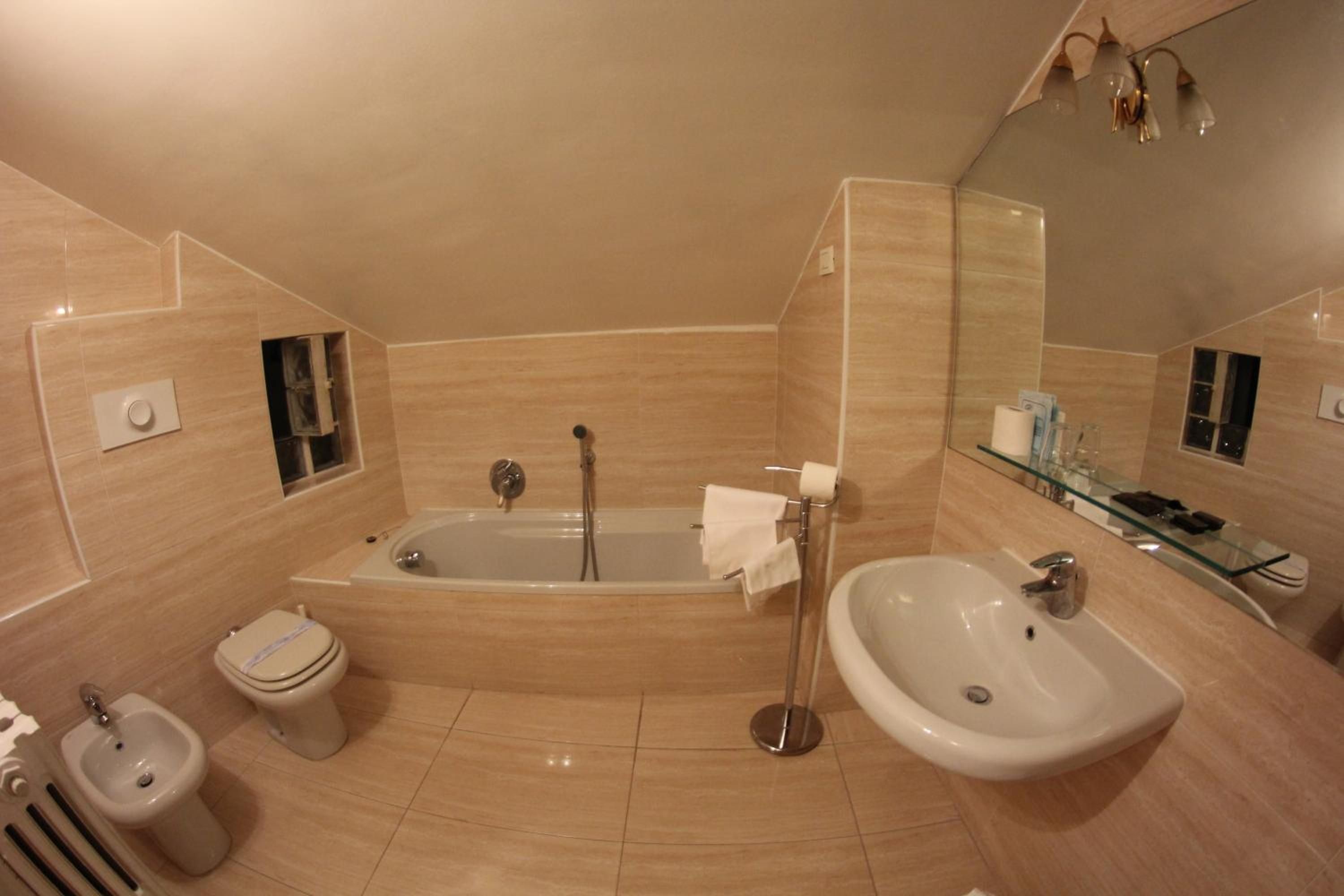 A modern bathroom with a bathtub, a sink, and a toilet.