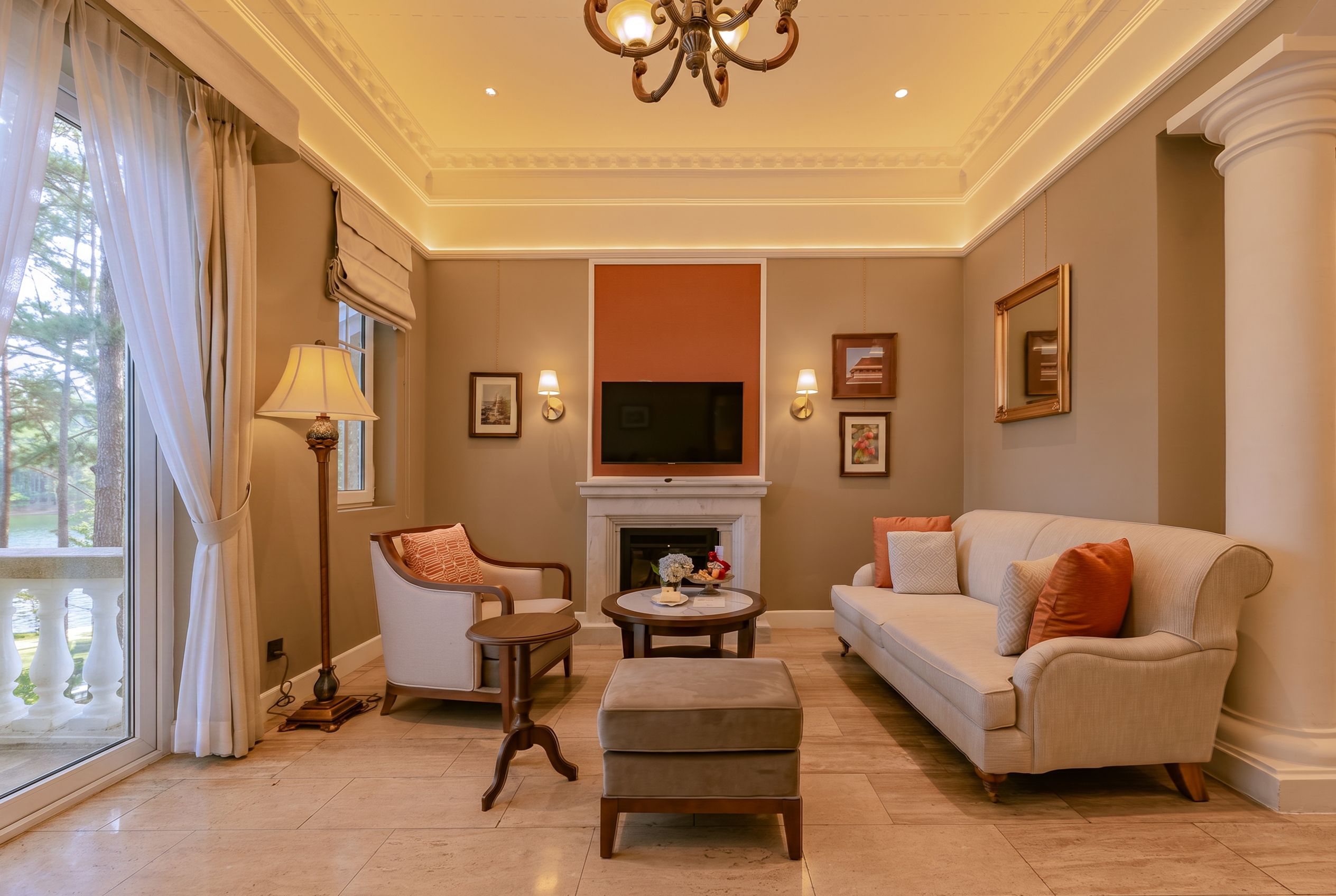 A living room with a fireplace, a sofa, a chair, and a television.