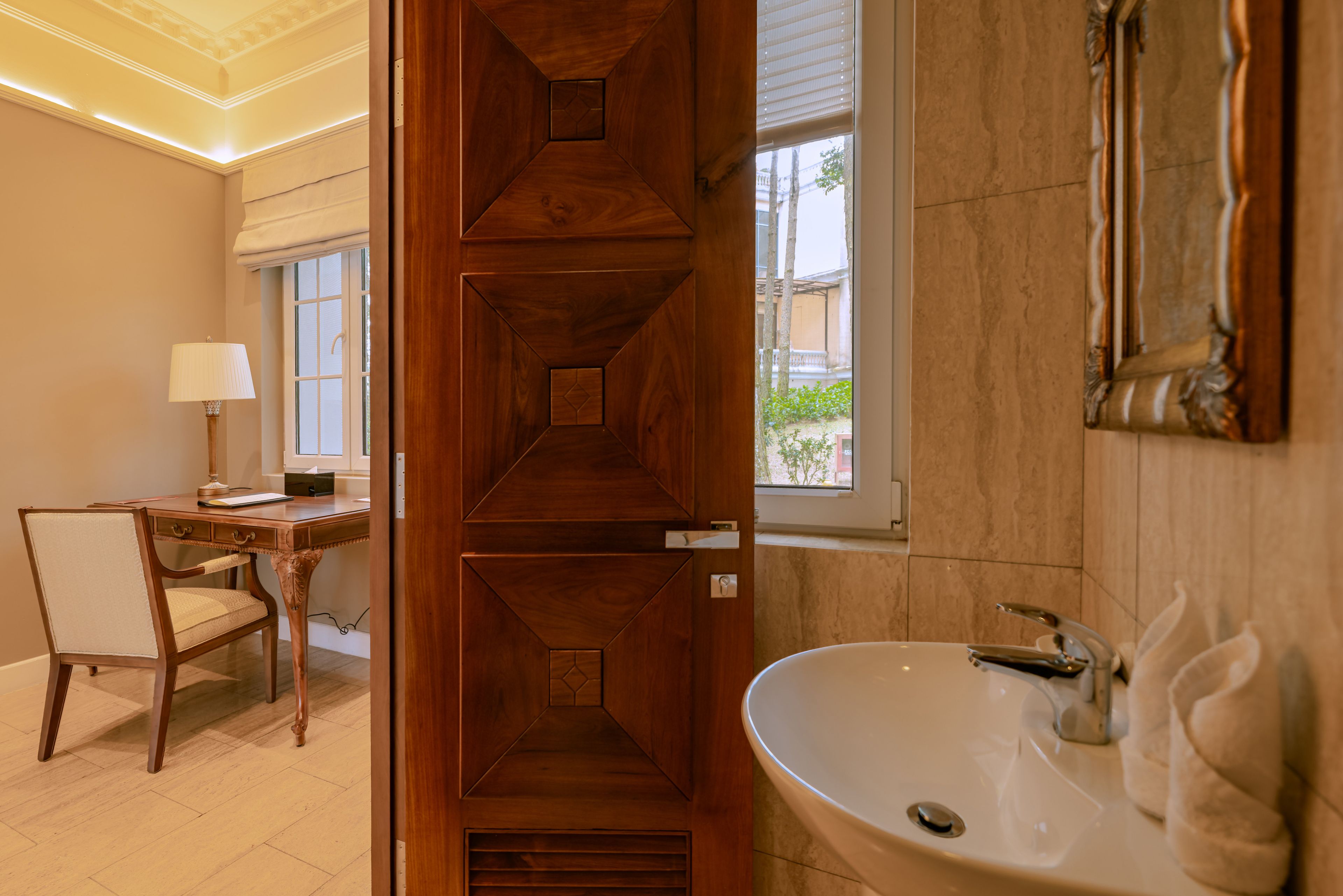 A bathroom with a wooden vanity, a sink, and a mirror.