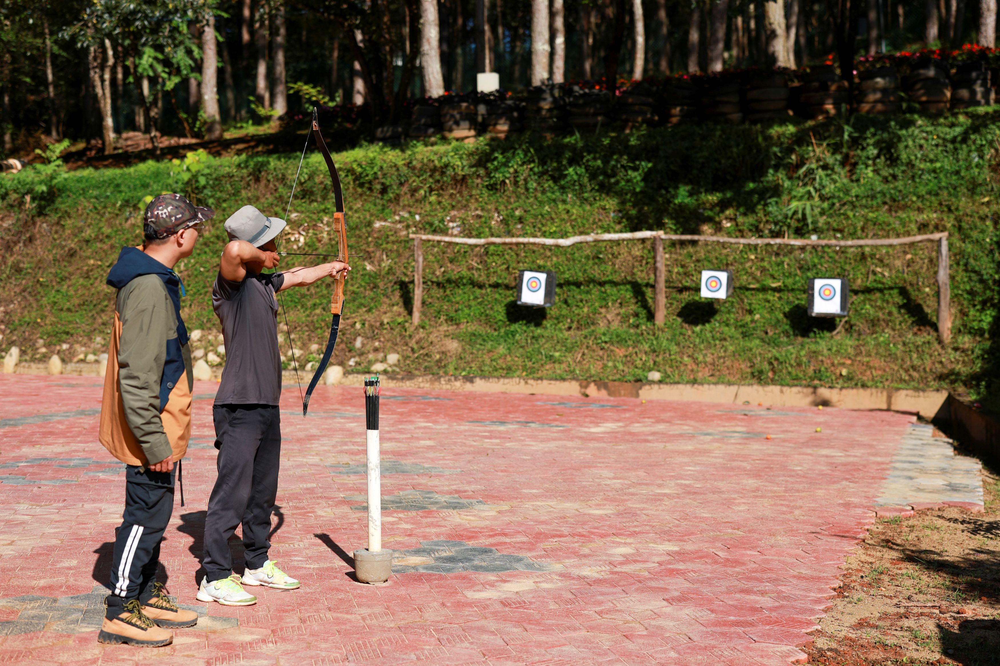 An outdoor archery range with targets and a shooting line.