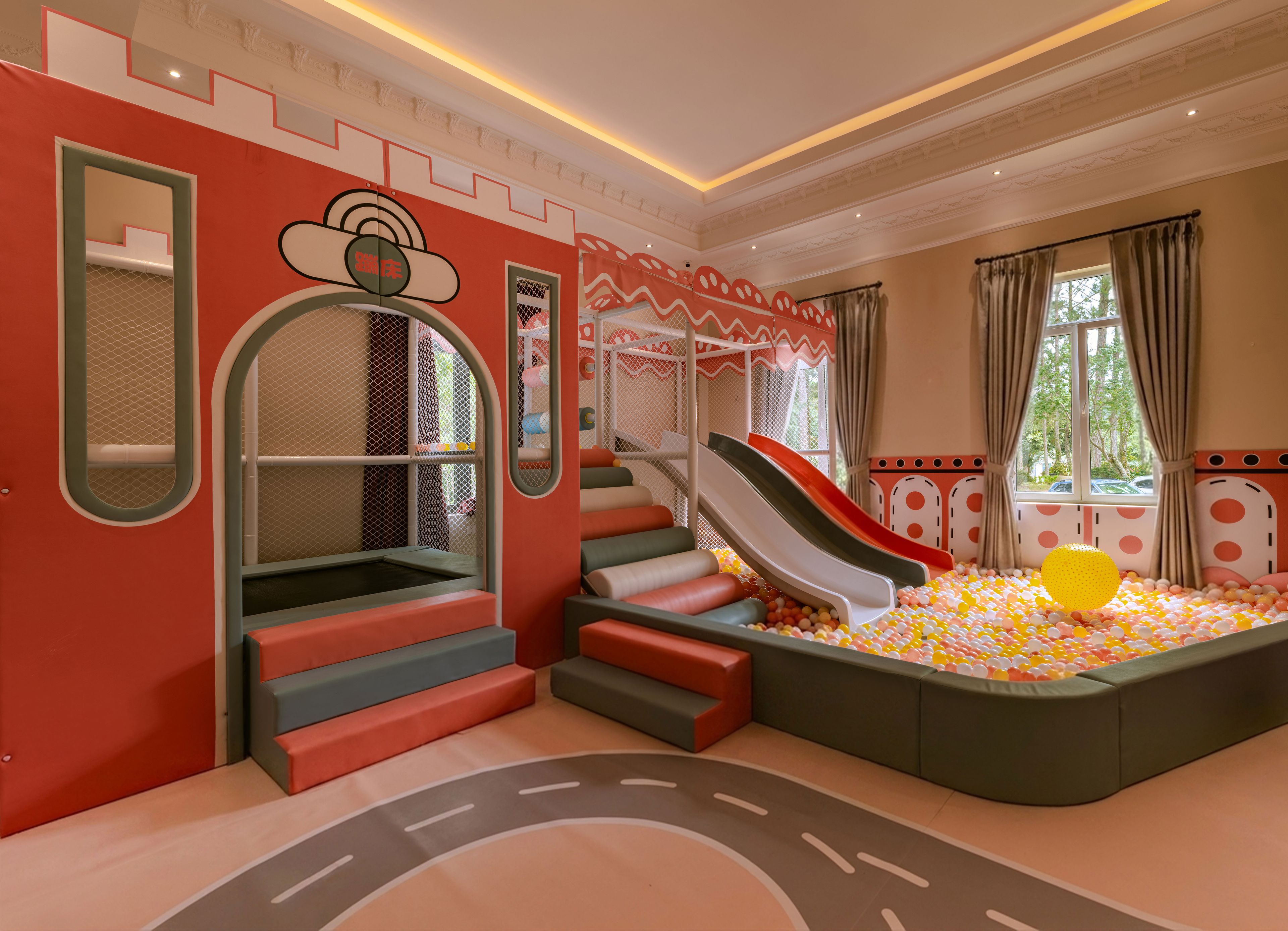 A children's play area with slides, a ball pit, and a climbing structure.