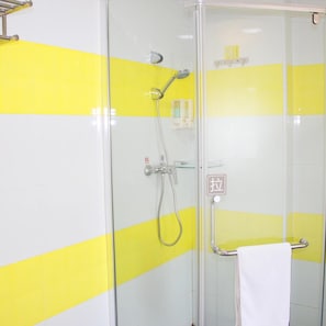 A glass-enclosed shower stall with a yellow and white tiled wall, a handheld showerhead, and a towel rack. - 7 Days Inn Bird's Nest Stadium (Beijing)
