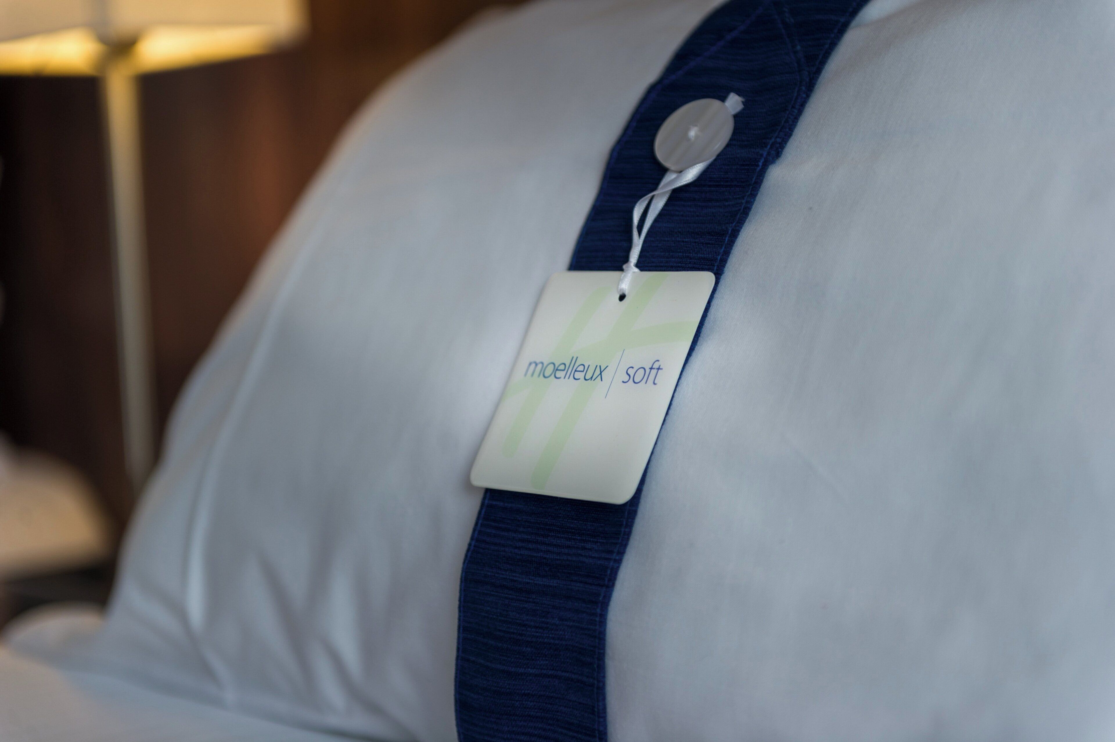 A pillow with a tag labeled 'melleux soft.'