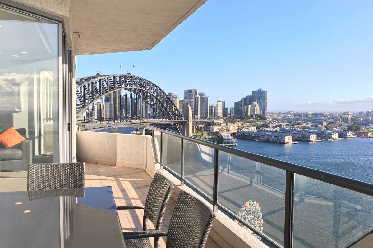 A balcony with a view of the Sydney Harbour Bridge and city skyline.
