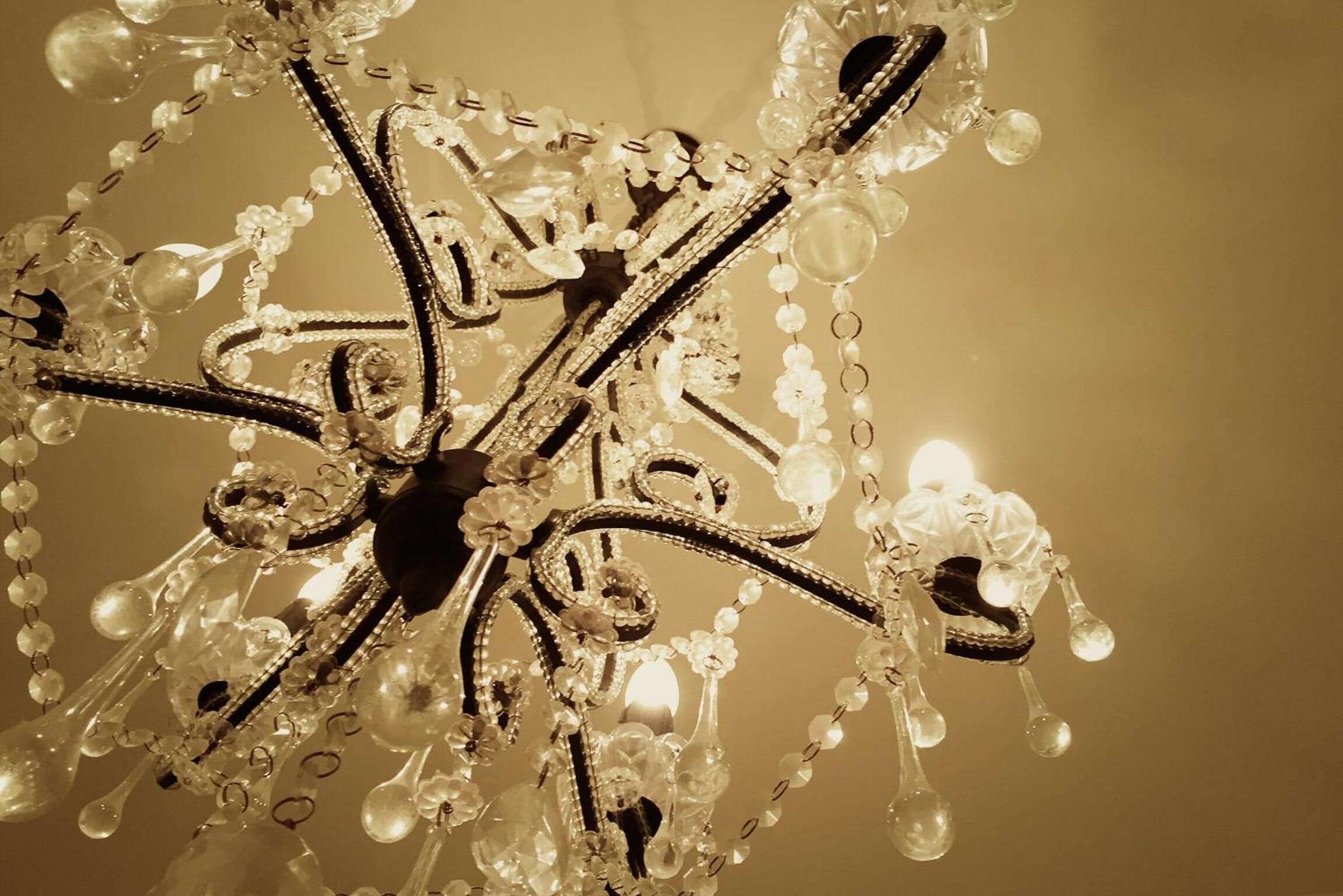A chandelier with multiple arms and hanging crystal elements.