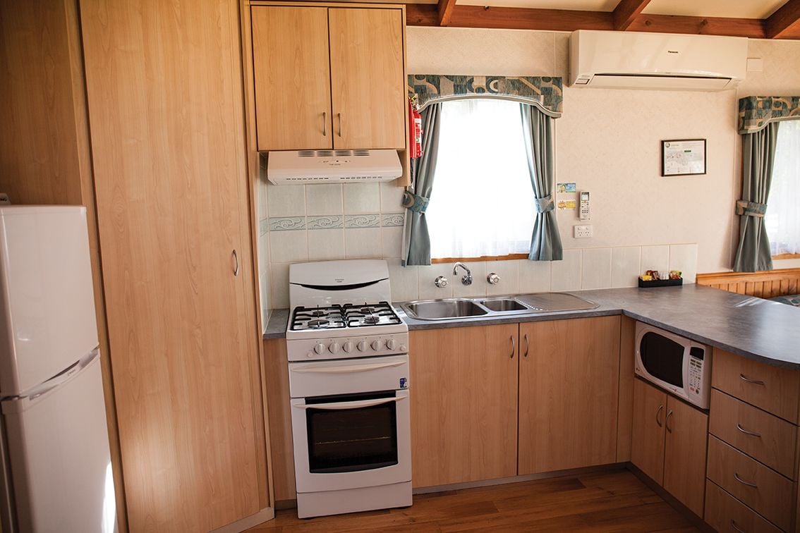 deluxe villa, 2 bedrooms | private kitchen | full-sized fridge, microwave, stovetop, cookware/dishes/utensils