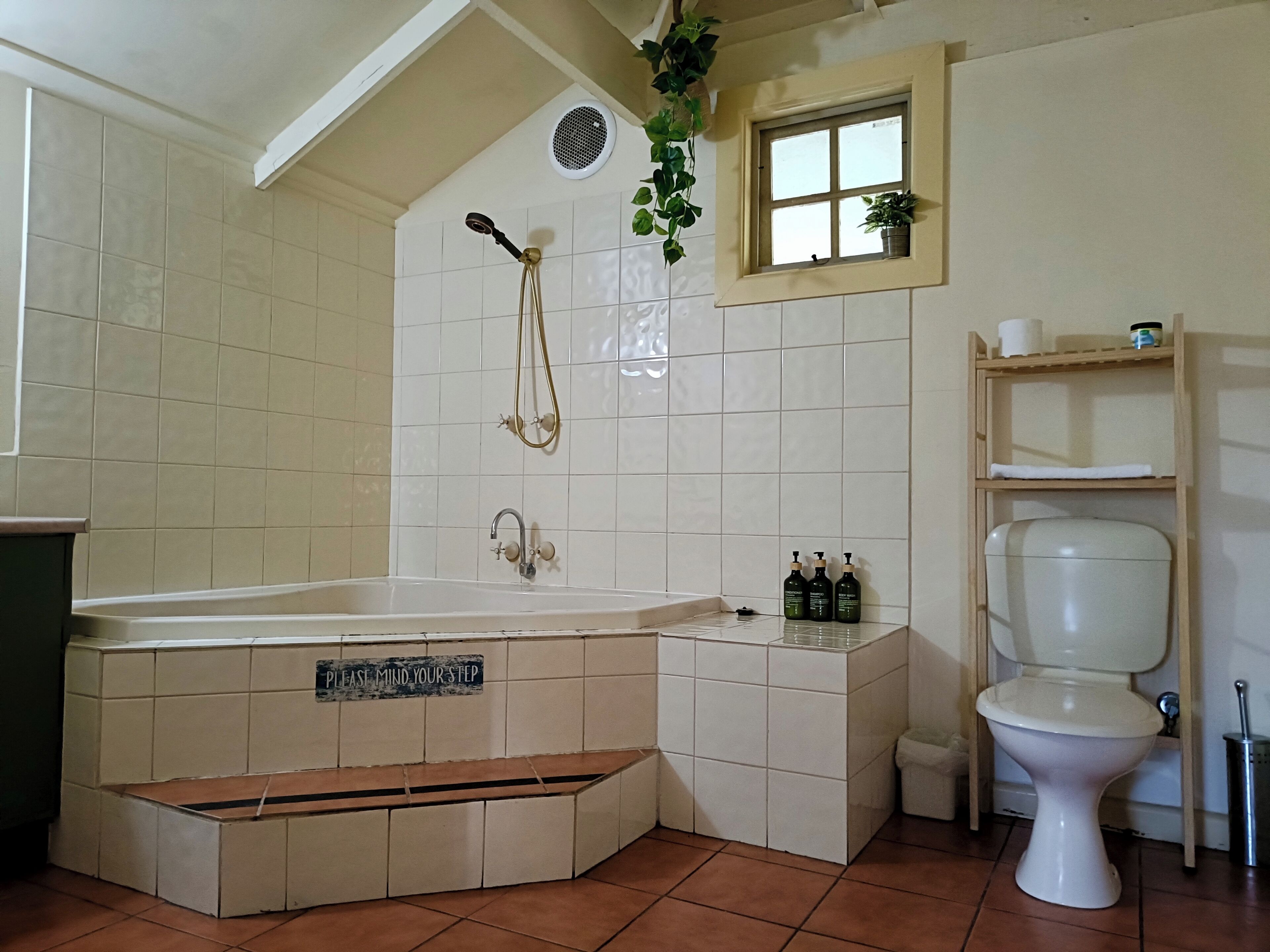 A bathroom with a bathtub, a toilet, a sink, and a shower.