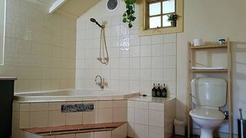A bathroom with a bathtub, a toilet, a sink, and a shower.