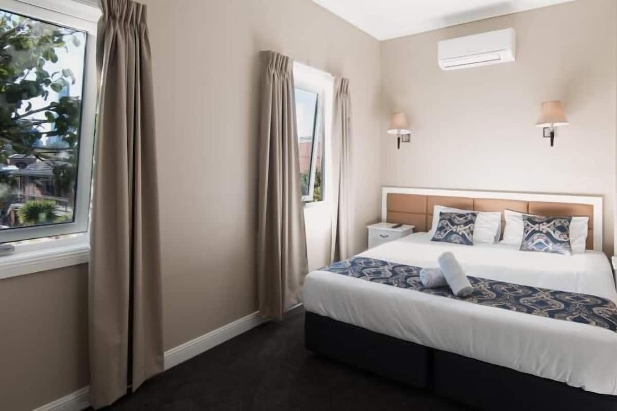 Desk, laptop workspace, blackout drapes, iron/ironing board