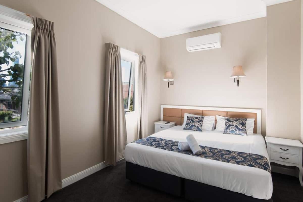 Desk, laptop workspace, blackout drapes, iron/ironing board