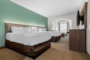A hotel room with a large bed, a desk, and a television. - Comfort Inn & Suites Scott-West Lafayette (Scott)