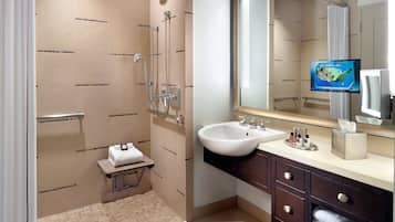 Un baño moderno con ducha, lavabo y tocador.