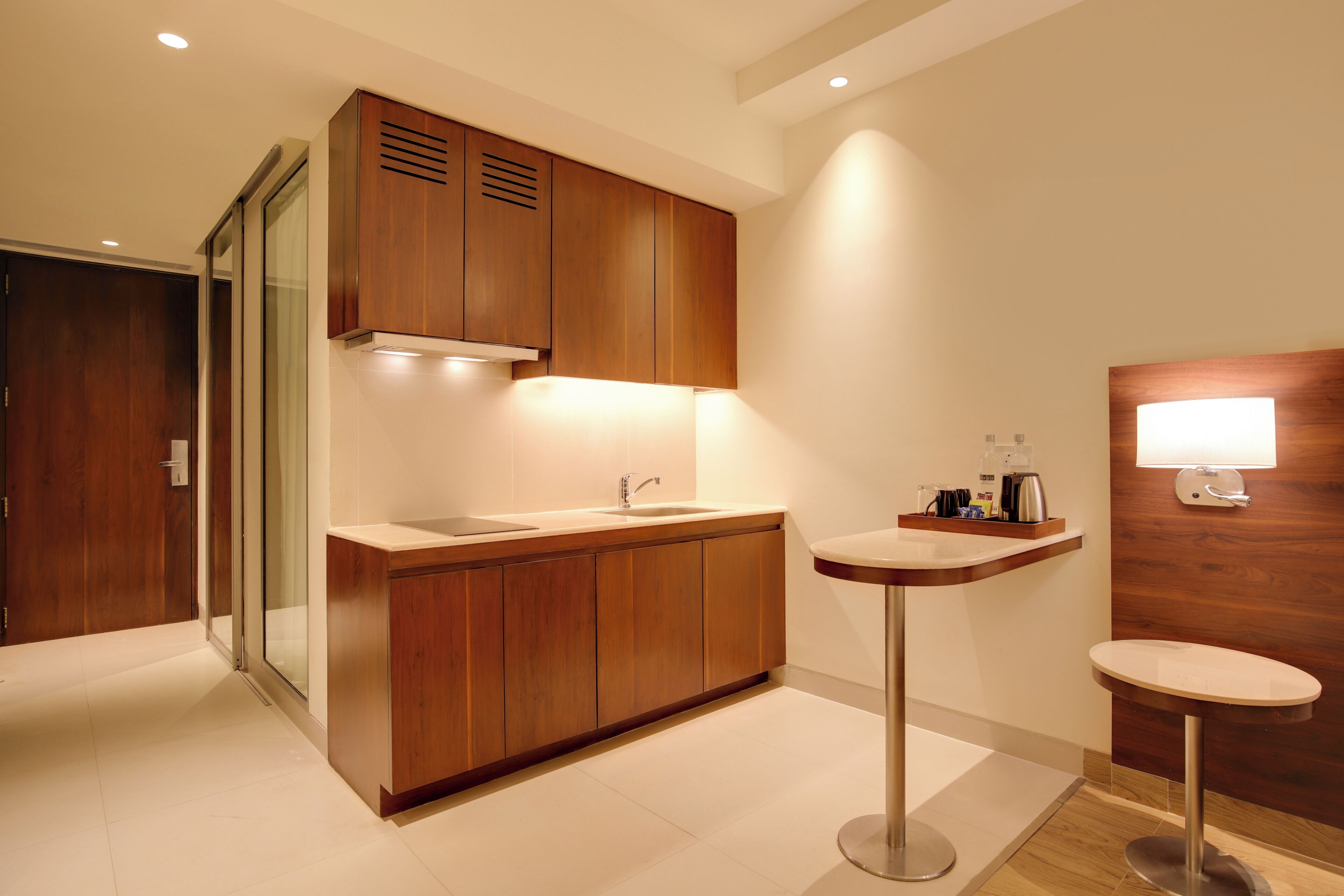 A modern bathroom with a wooden vanity, a sink, and a mirror.