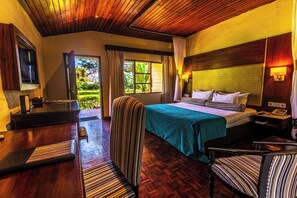 A hotel room with a bed, a desk, a chair, a TV, and a view of the outdoors. - Muthu Lake Naivasha Country Club, Naivasha (Naivasha)