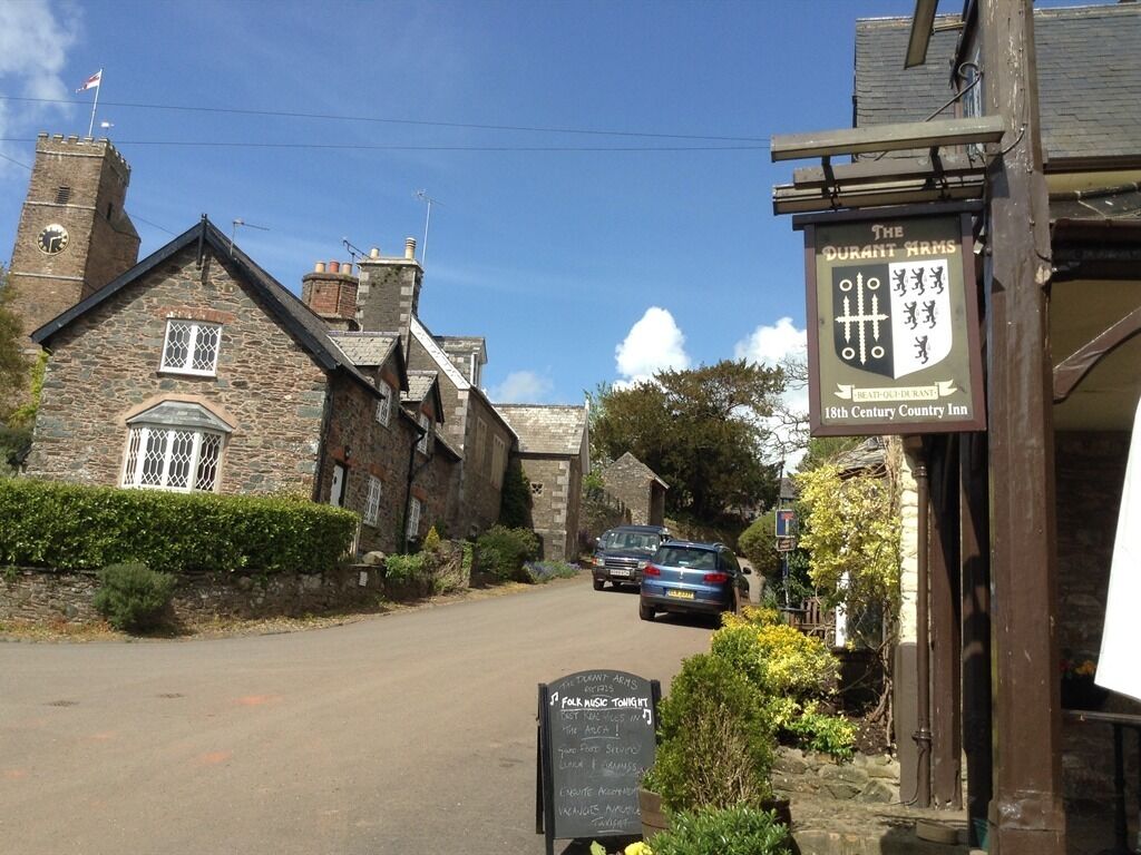 A traditional stone building with a sign for 'The Great Arms 18th Century Country Inn'.