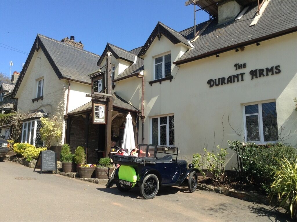 A traditional pub named "The Durant Arms" with a vintage car parked outside.