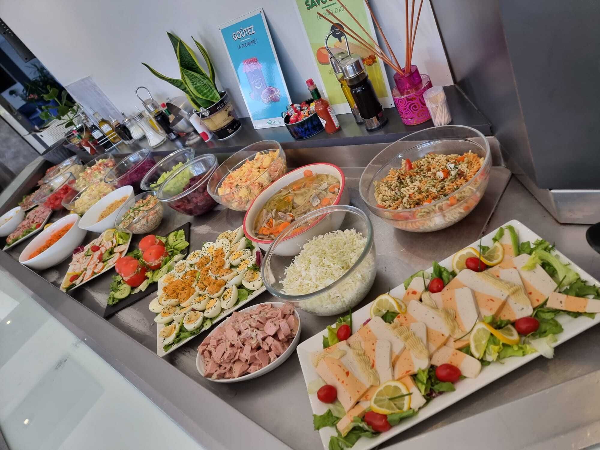 A buffet with various dishes including salads, rice, and seafood.